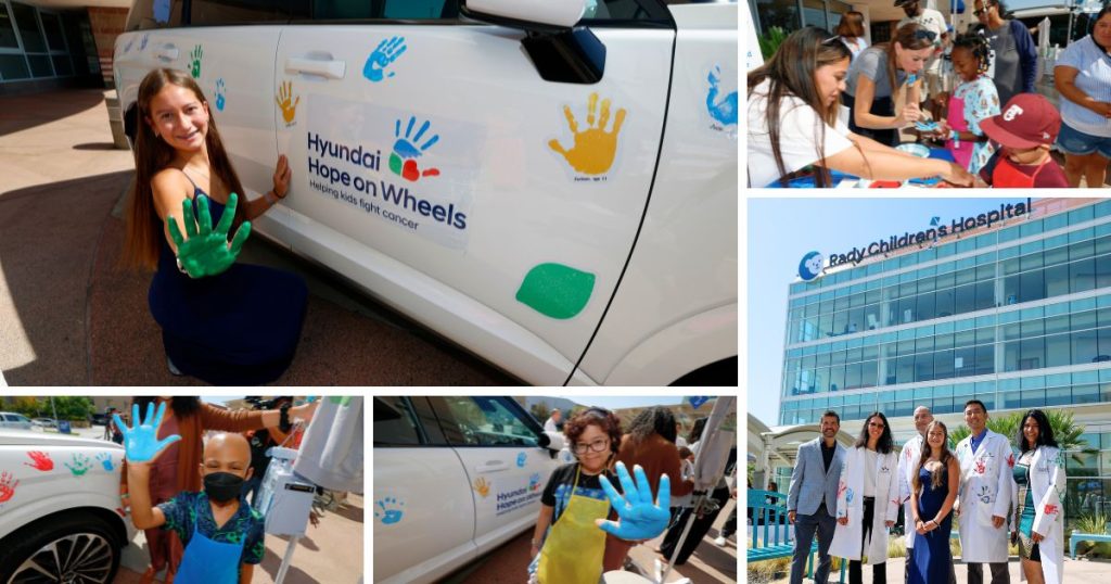 Children placing their painted handprints on a Hyundai vehicle during the Handprint Ceremony