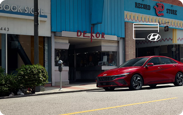 Red Hyundai Elantra parked outside a record store with Hyundai Pay display