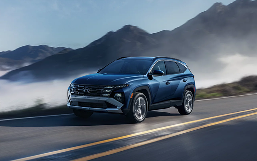 2026 Hyundai Tucson Hybrid front view driving in mountains