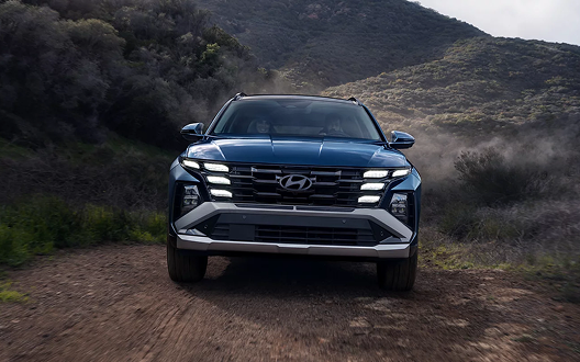 2026 Hyundai Tucson Hybrid front view on dirt road