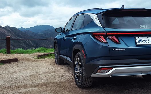 2026 Hyundai Tucson Hybrid rear quarter view in mountains