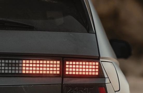 Close-up of the glowing pixel taillight and XRT badge on the IONIQ 5 XRT