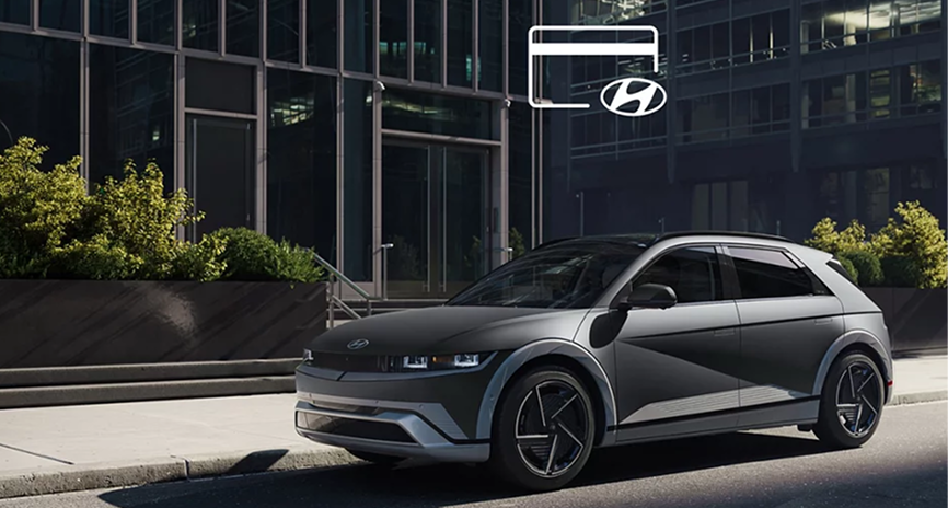 A gray IONIQ 5 plugged in at a city charger with a credit card icon floating above it