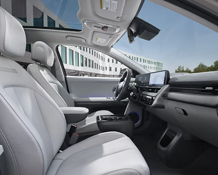 The light gray front seats and center console of the IONIQ 5