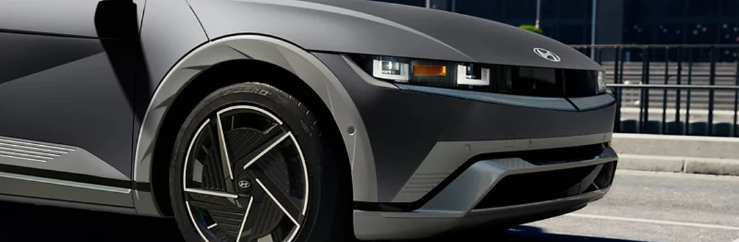 Close-up of the front wheel and pixel headlight of a gray IONIQ 5