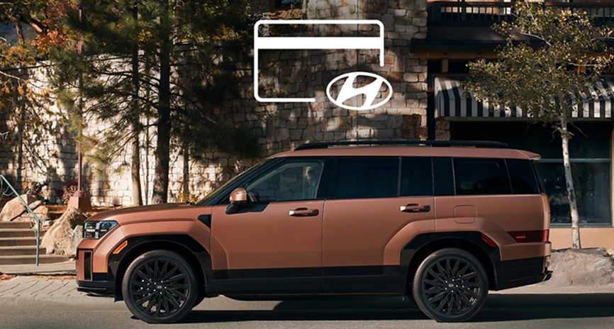 A copper SANTA FE parked outside a lodge with a credit card icon above it