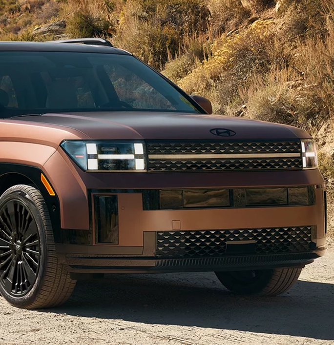 A copper SANTA FE Hybrid on a hillside seen from the front