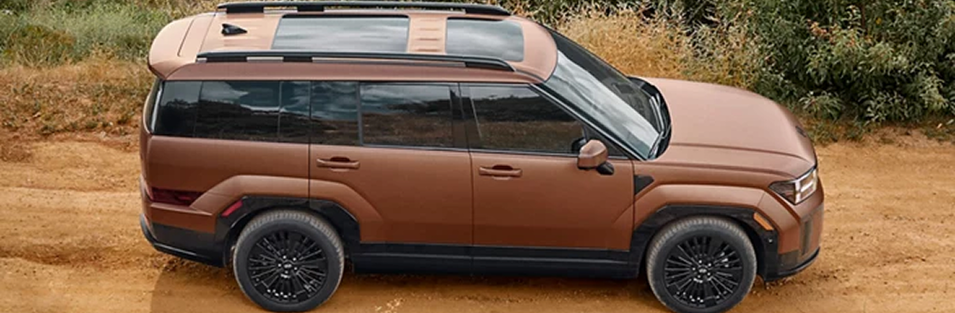 A copper SANTA FE Hybrid in profile on a dirt road