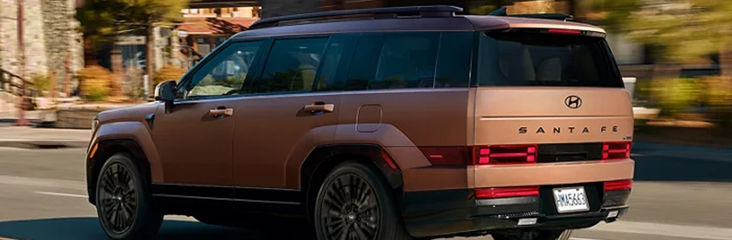 A copper SANTA FE Hybrid driving through town