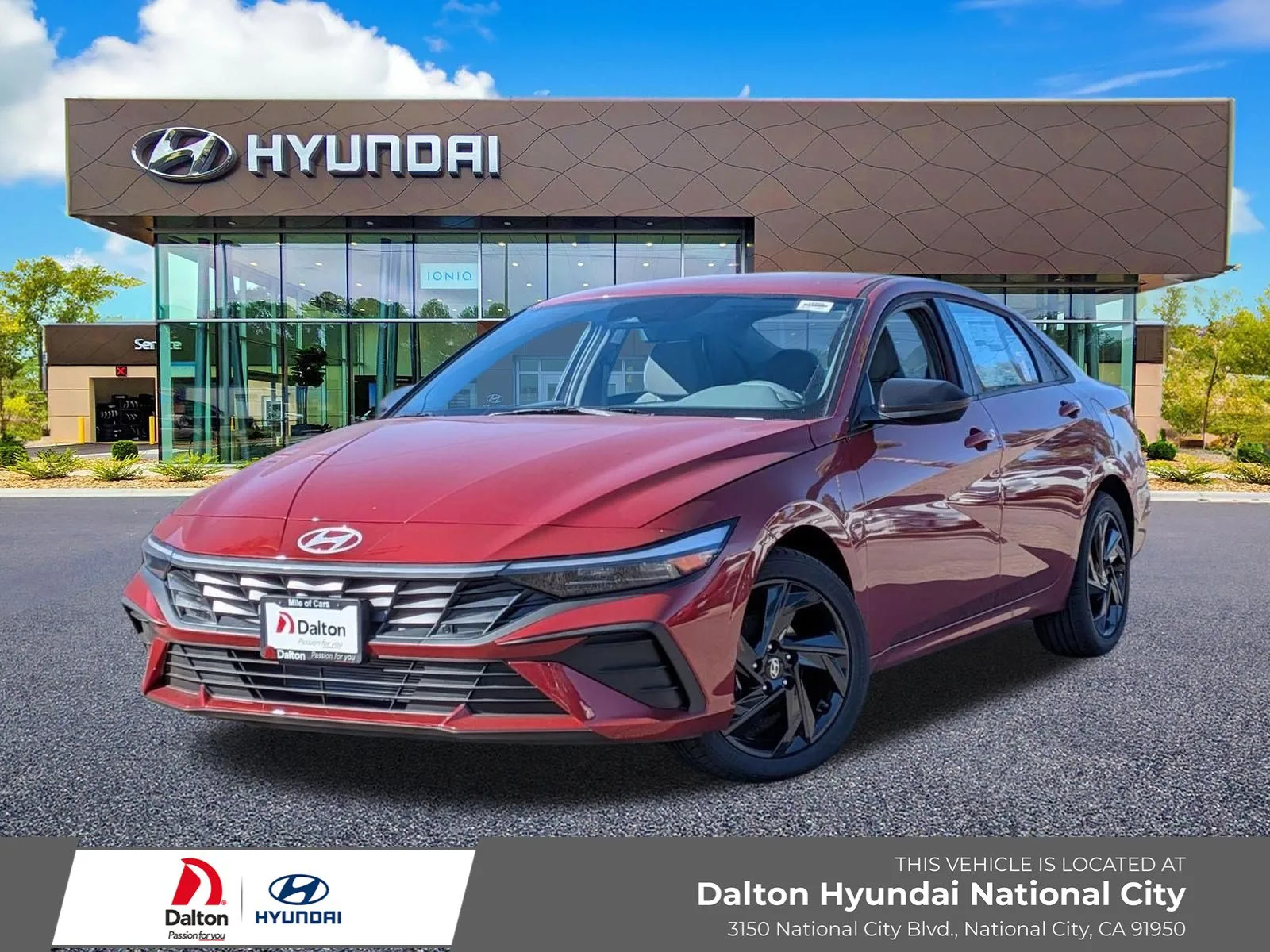 Red 2026 Hyundai Elantra, front three-quarter view, parked in front of the Dalton Hyundai National City showroom
