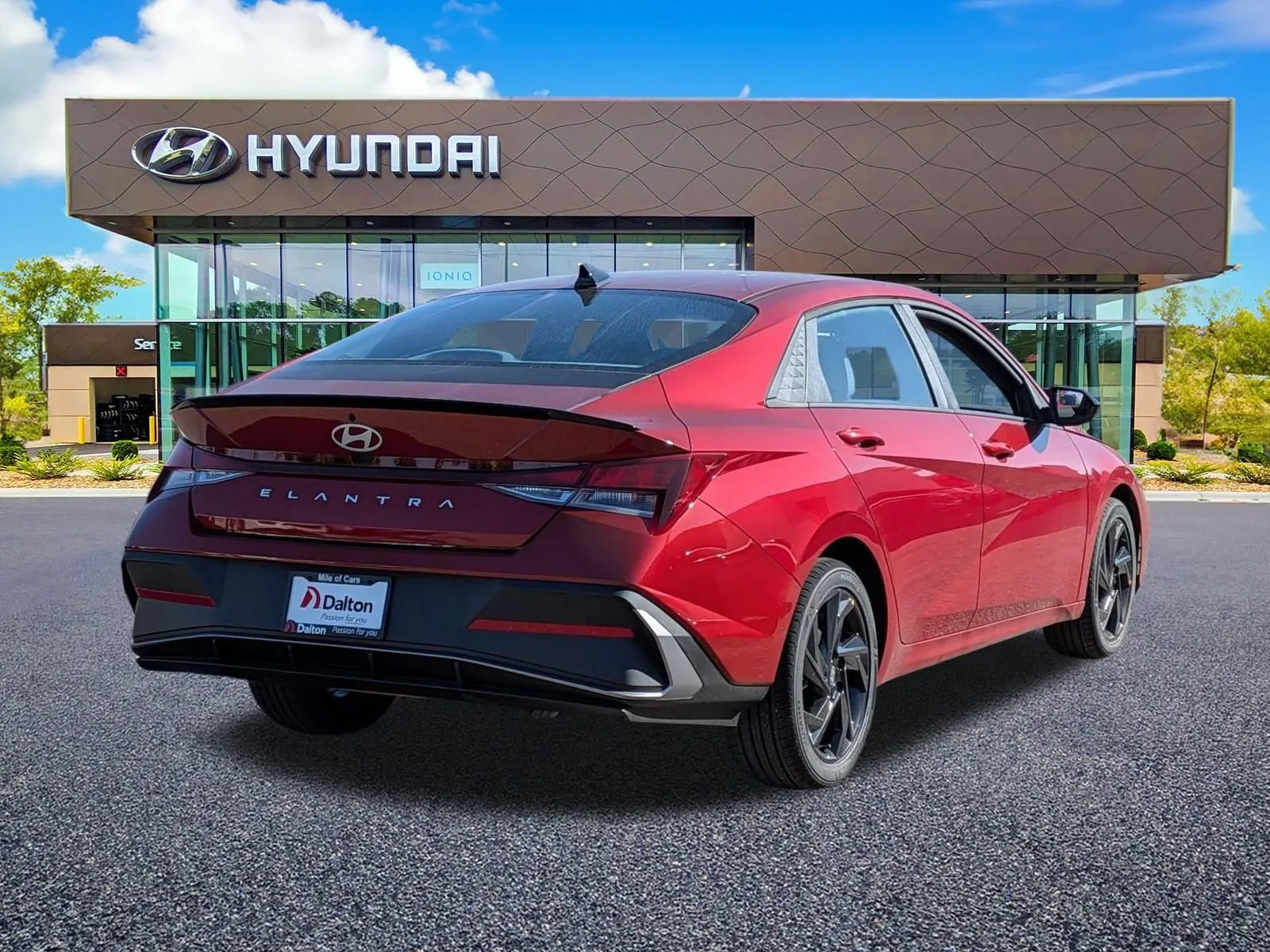 Rear three-quarter view of a red 2026 Hyundai Elantra outside the Dalton showroom