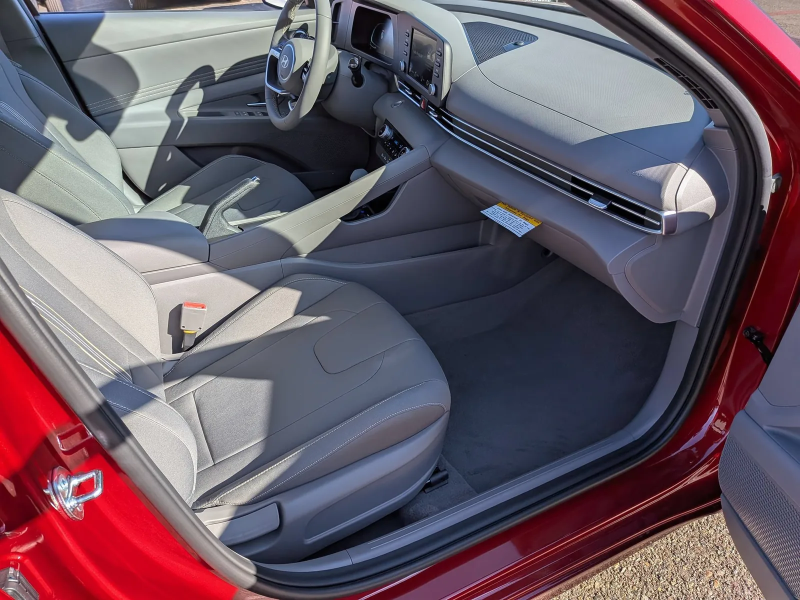 Front seats and door of the red 2026 Hyundai Elantra