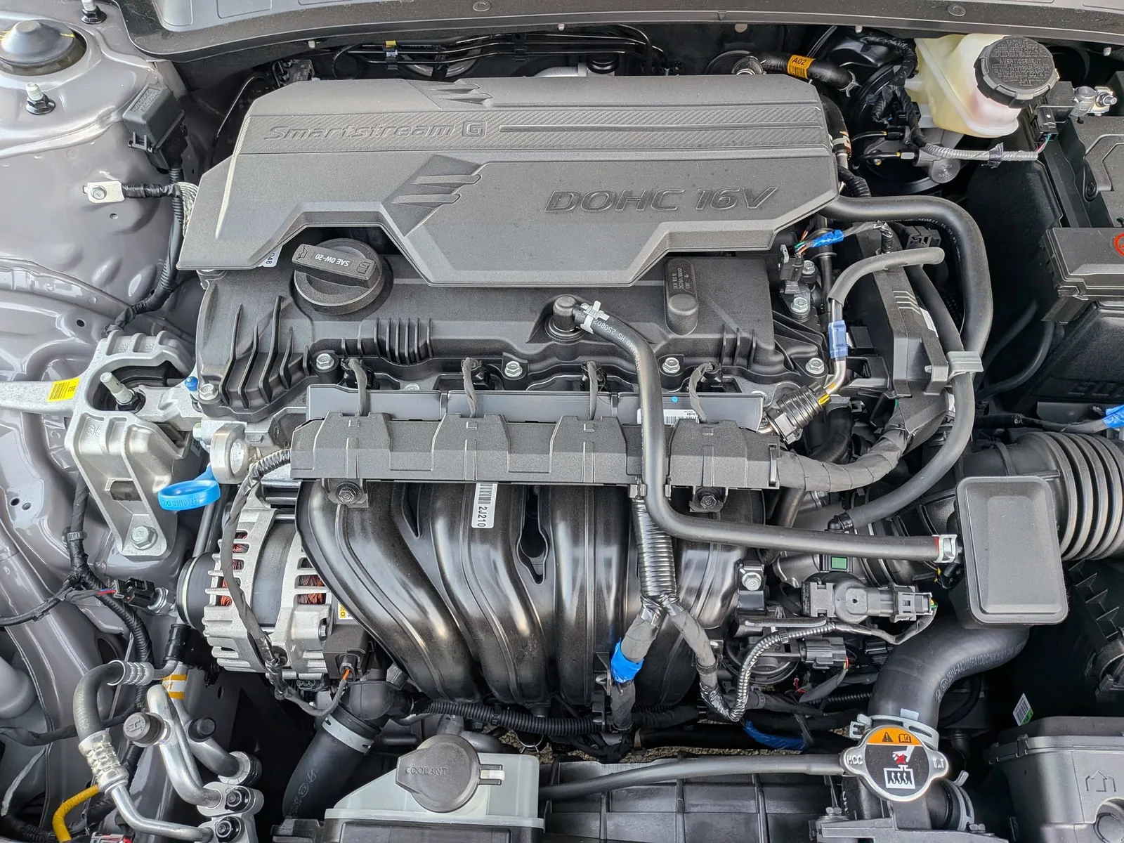 Engine bay of the 2026 Hyundai Elantra showing the DOHC 16-valve engine