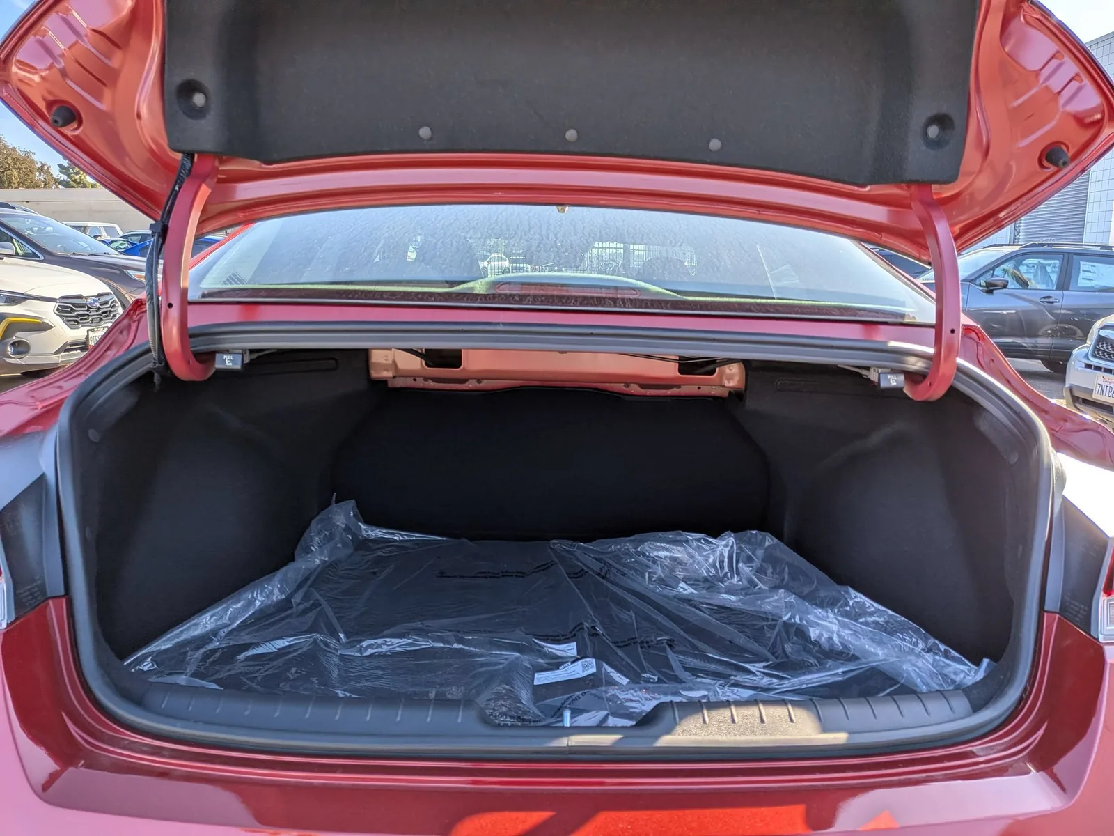Open trunk of the red 2026 Hyundai Elantra