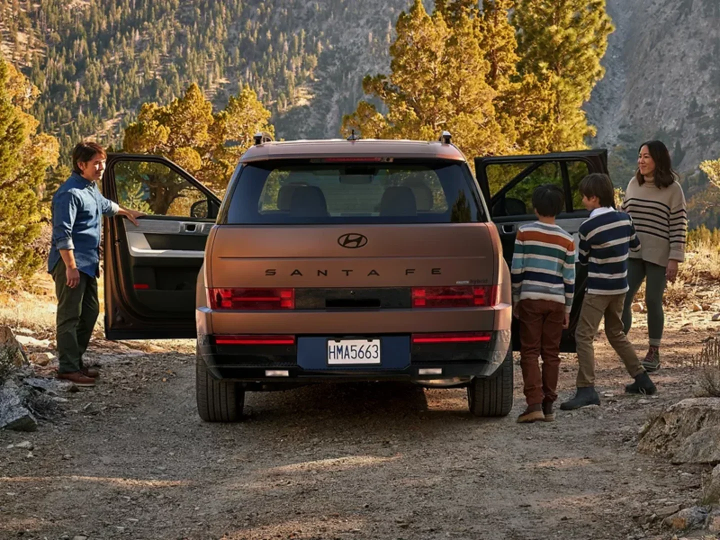 2026 Hyundai Santa Fe Hybrid with a family at a mountain trailhead, leasing at Dalton Hyundai National City, CA