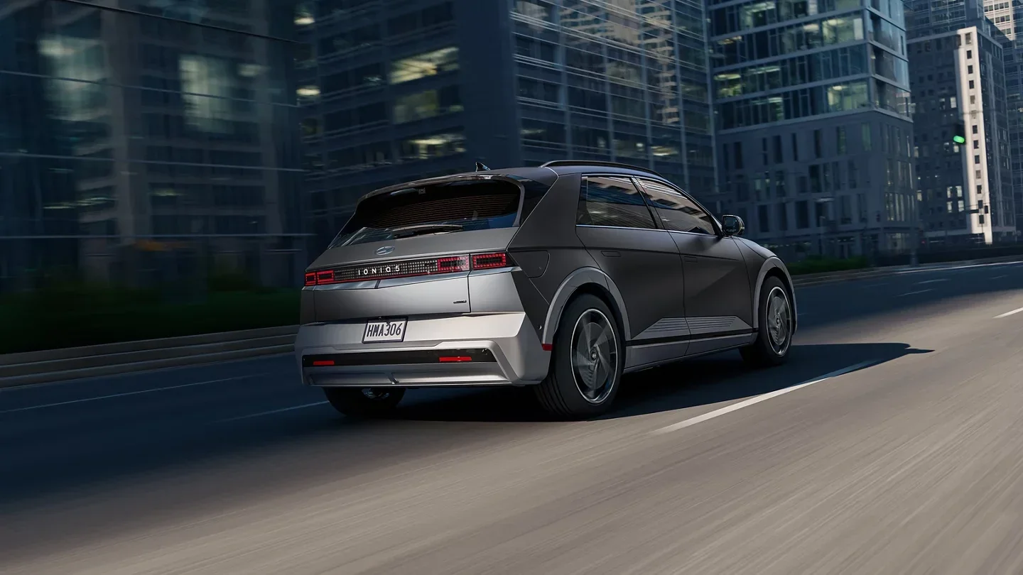 A silver 2027 Hyundai IONIQ 5 driving through the city.