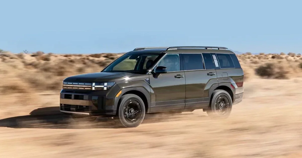 A 2026 Hyundai Santa Fe XRT driving through desert sand.
