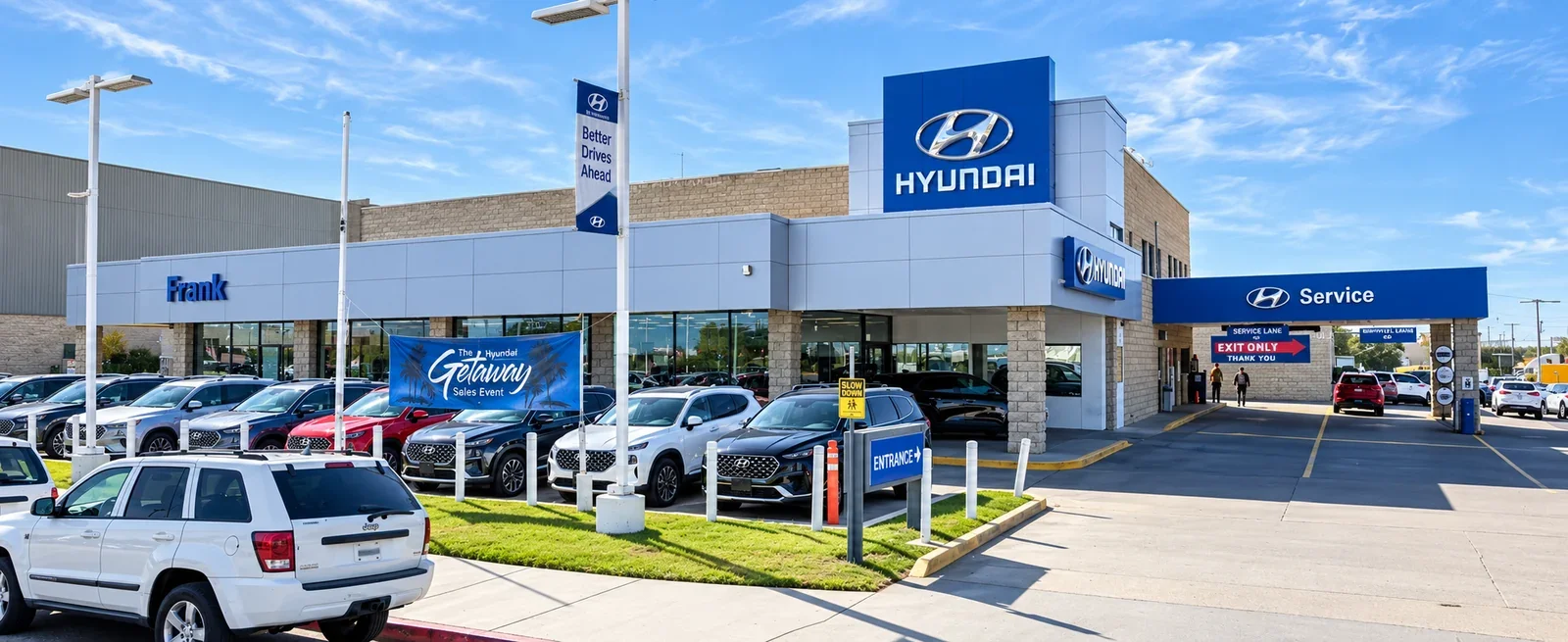 A Hyundai showroom with its service drive and a row of cars on the lot out front.