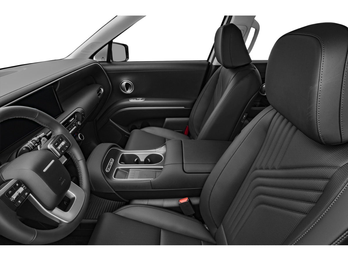 The front seats and center console of a Hyundai Palisade, seen from the second row.