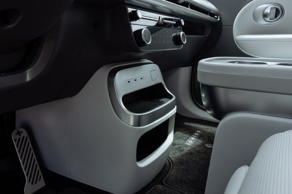 The rear face of the IONIQ 9 center console, with second-row climate vents and storage