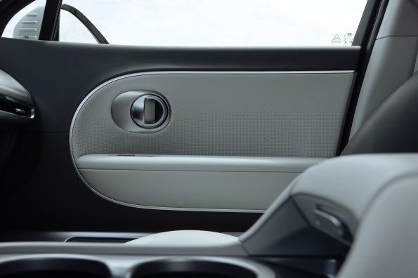 The IONIQ 9 second-row door panel, showing the trim and speaker grille