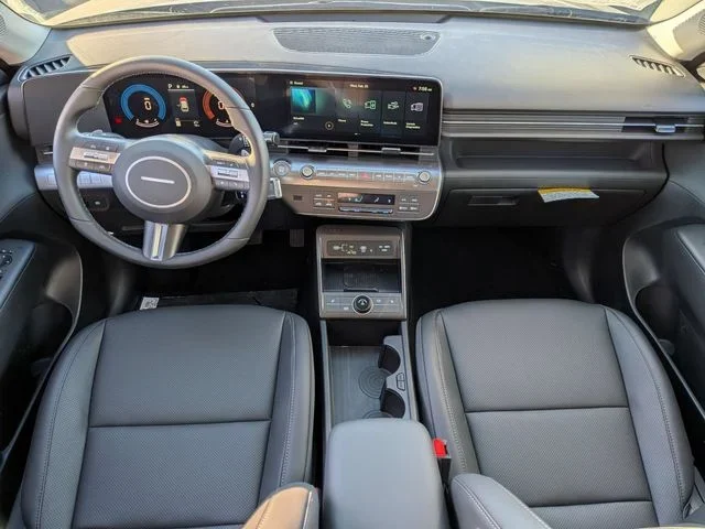 The full Hyundai Kona dashboard viewed head-on, twin displays under one pane above the front seats