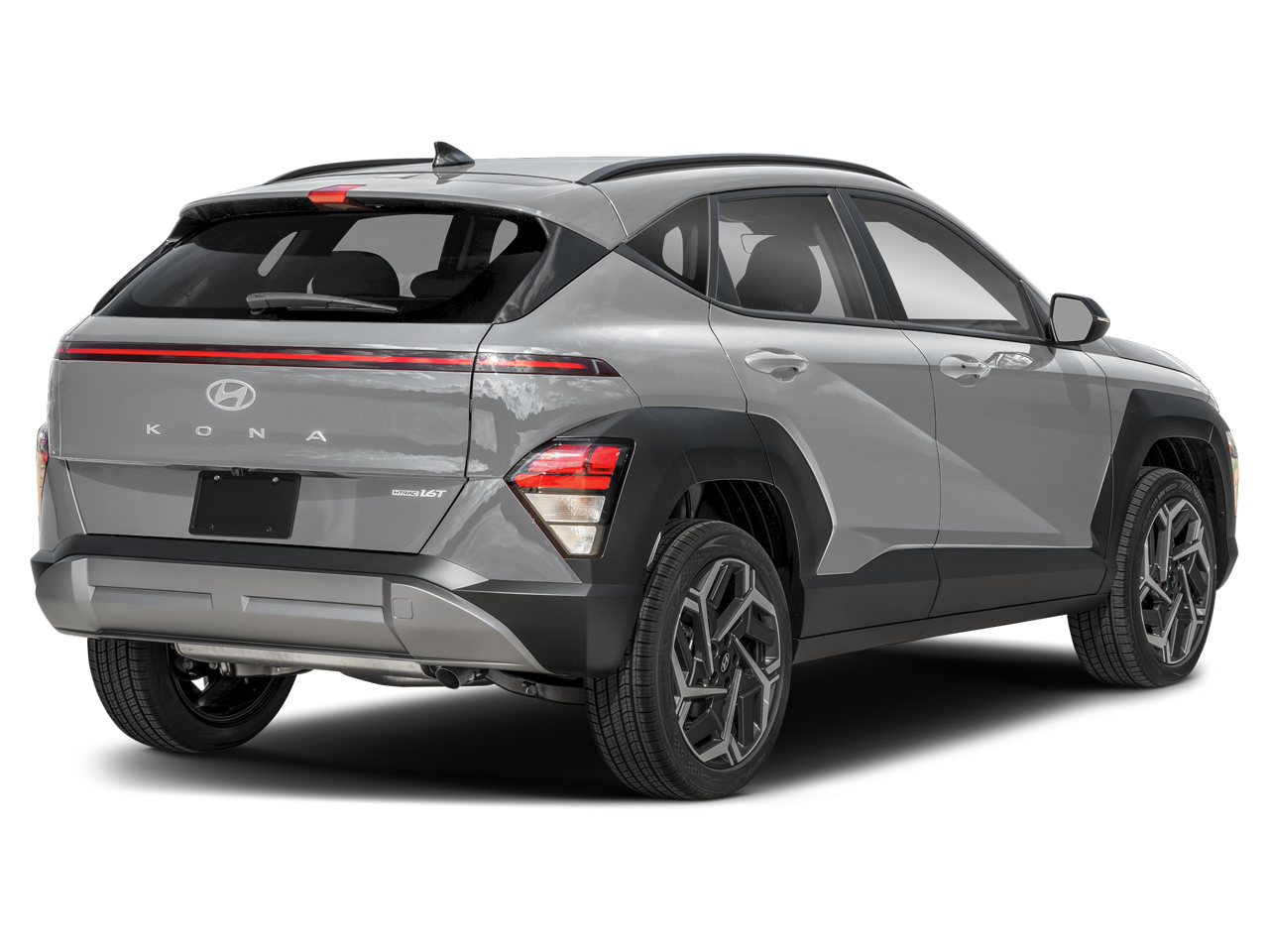 A rear three-quarter view of a gray Hyundai Kona showing the full-width tail light bar and KONA badge