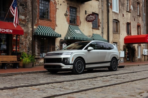 A white Hyundai IONIQ 9 parked on a city street, the kind of everyday driving a lease term and mileage allowance get built around